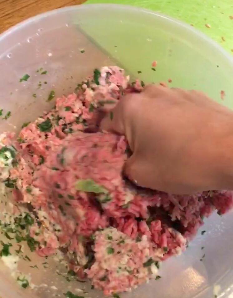 Mixing beef mince, chopped kales and soaked breadcrumbs